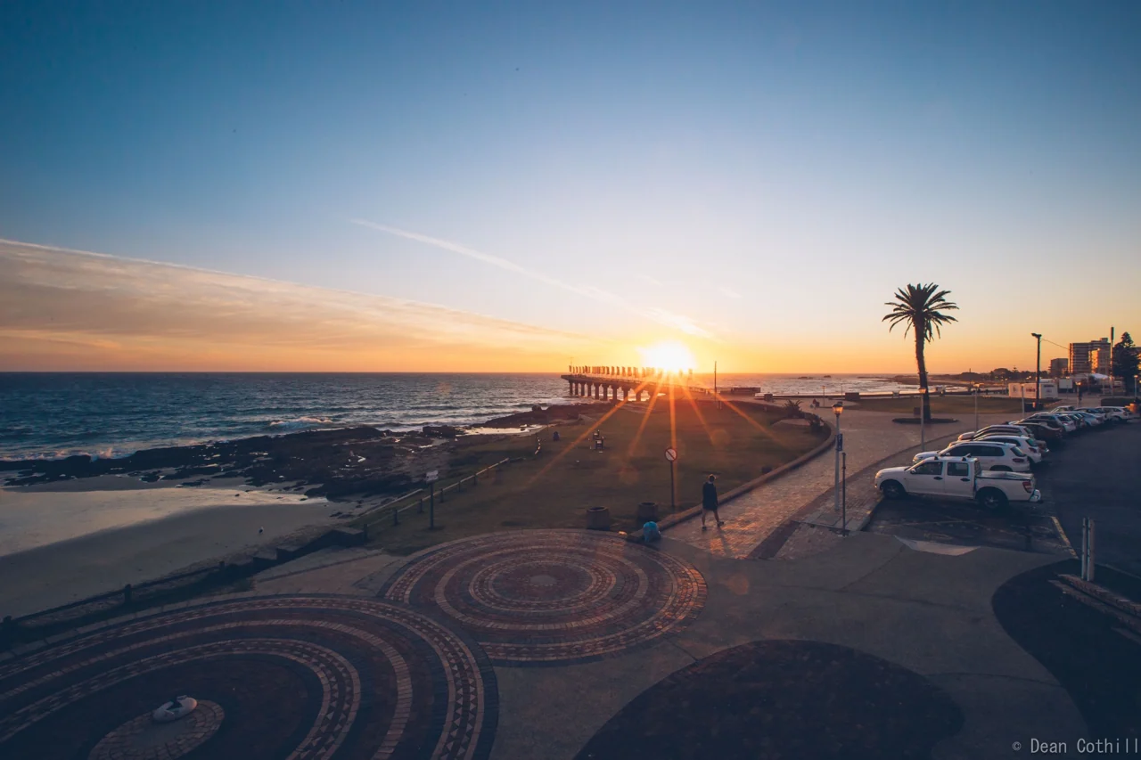 Sunrise over the Gqeberha beachfront promenade